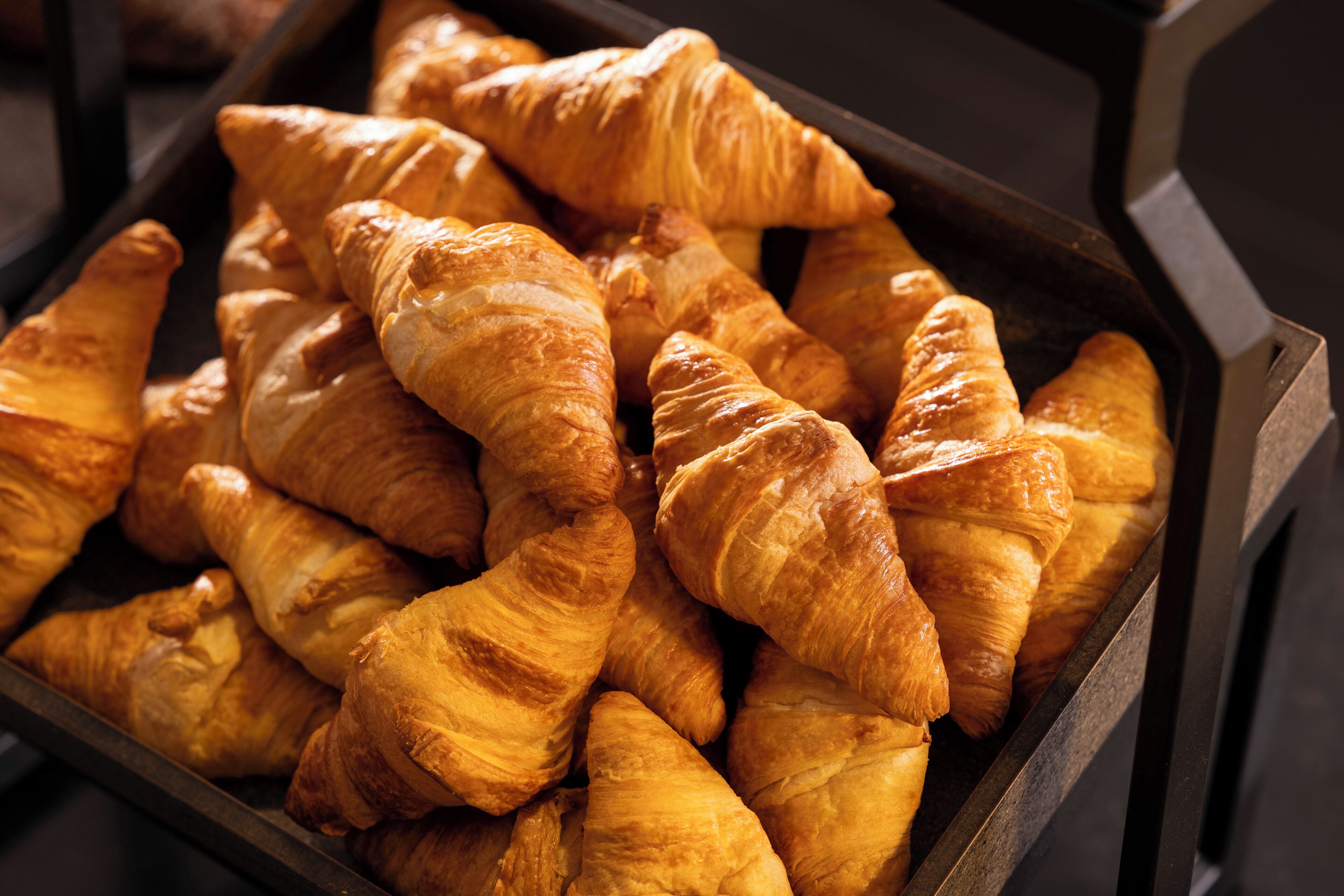 A tray of assorted pastries, including croissants and other baked goods.