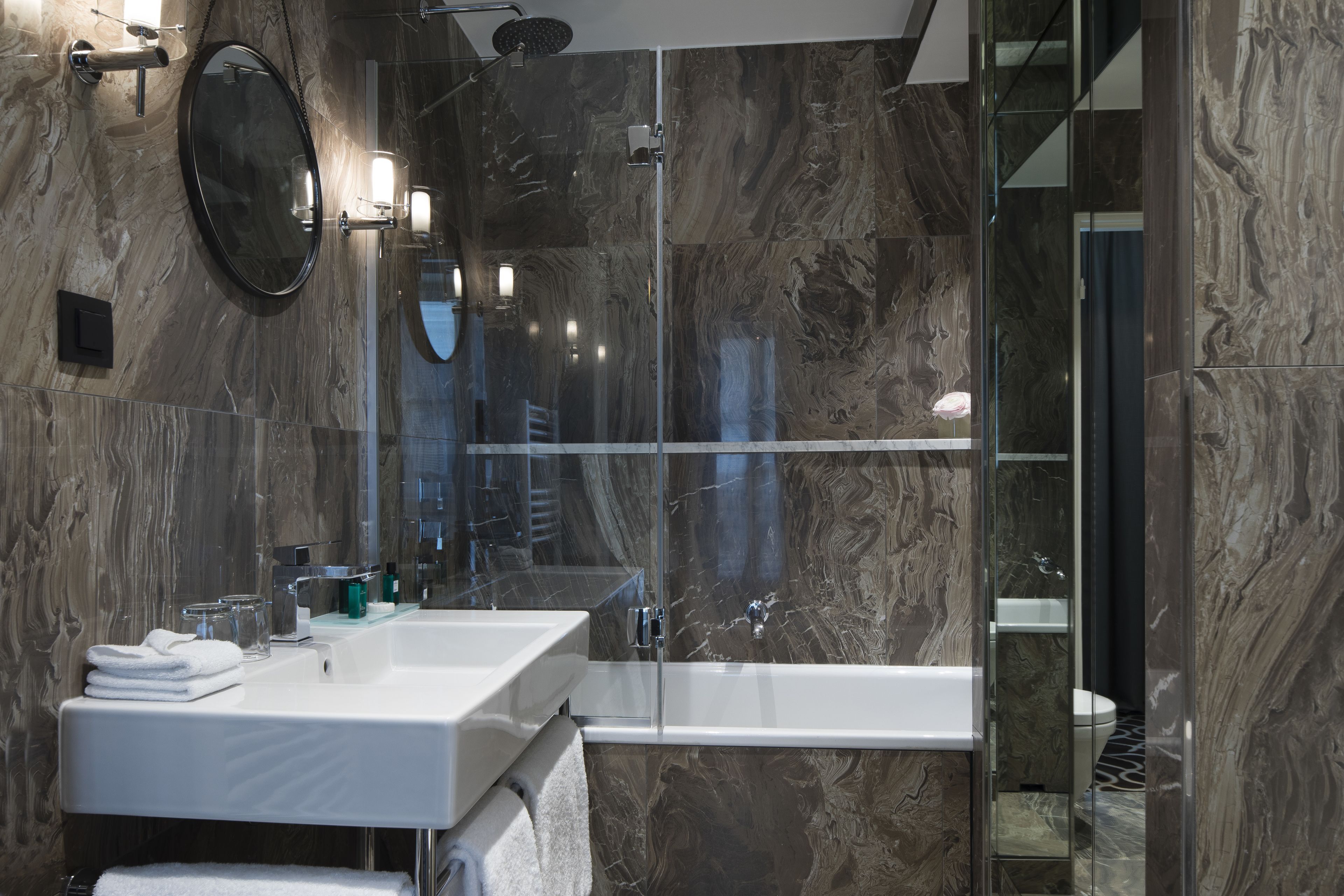 deluxe suite (parisienne) | bathroom | rainfall showerhead, designer toiletries, hair dryer, bathrobes