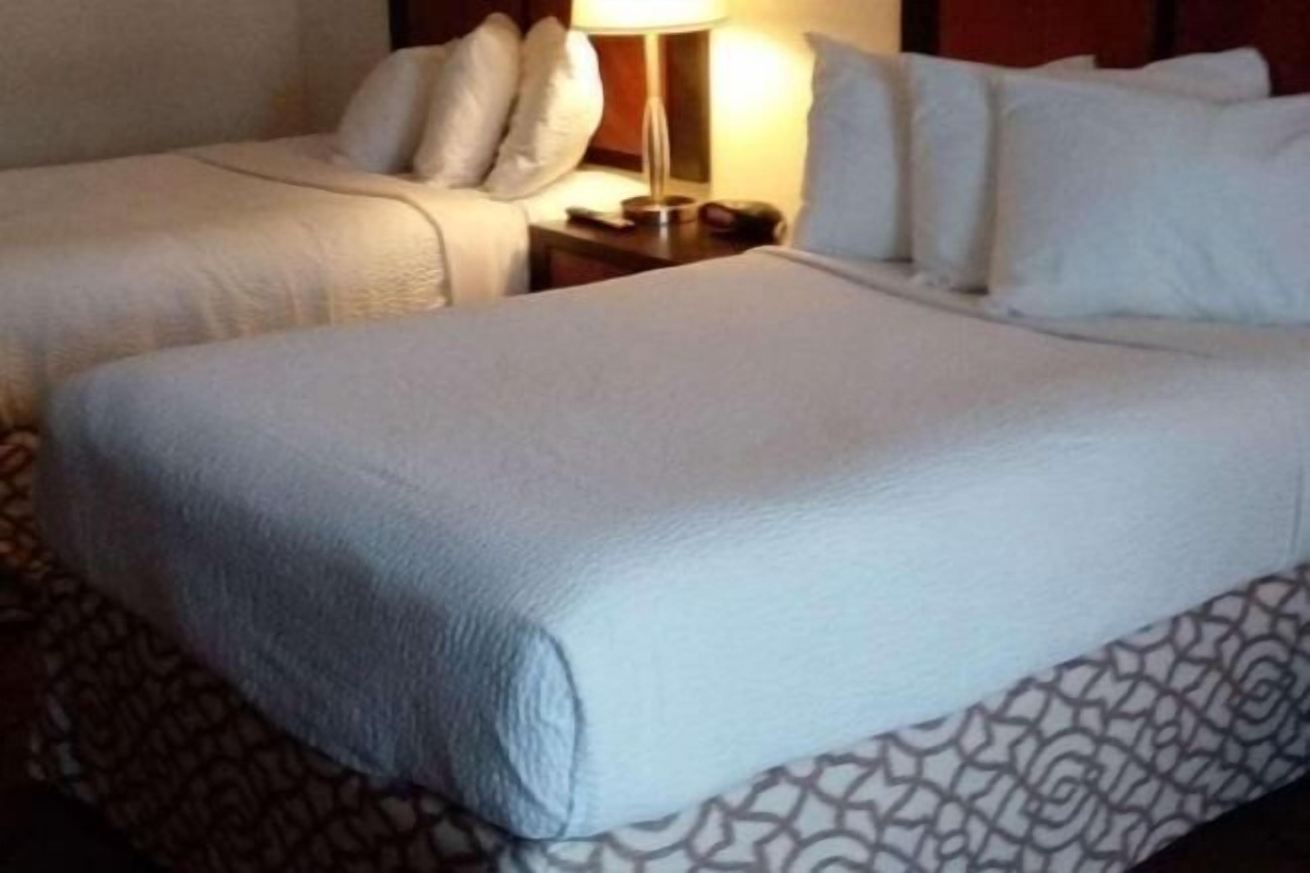 Premium bedding, pillow-top beds, desk, laptop workspace