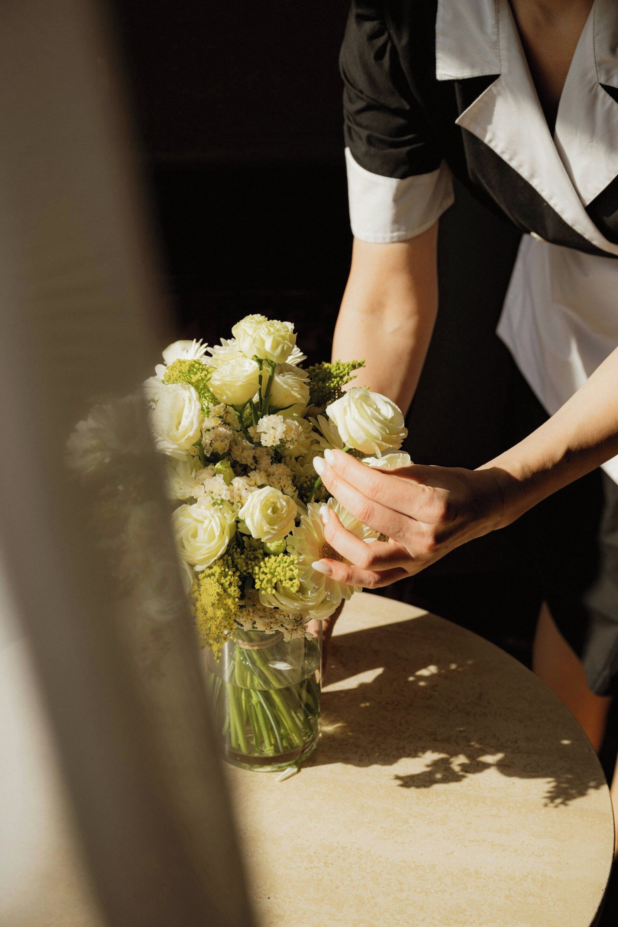 A person holding a bouquet of white flowers.