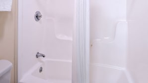 A white bathtub with chrome fixtures and a shower curtain. - Americas Best Value Inn Sullivan (Sullivan)