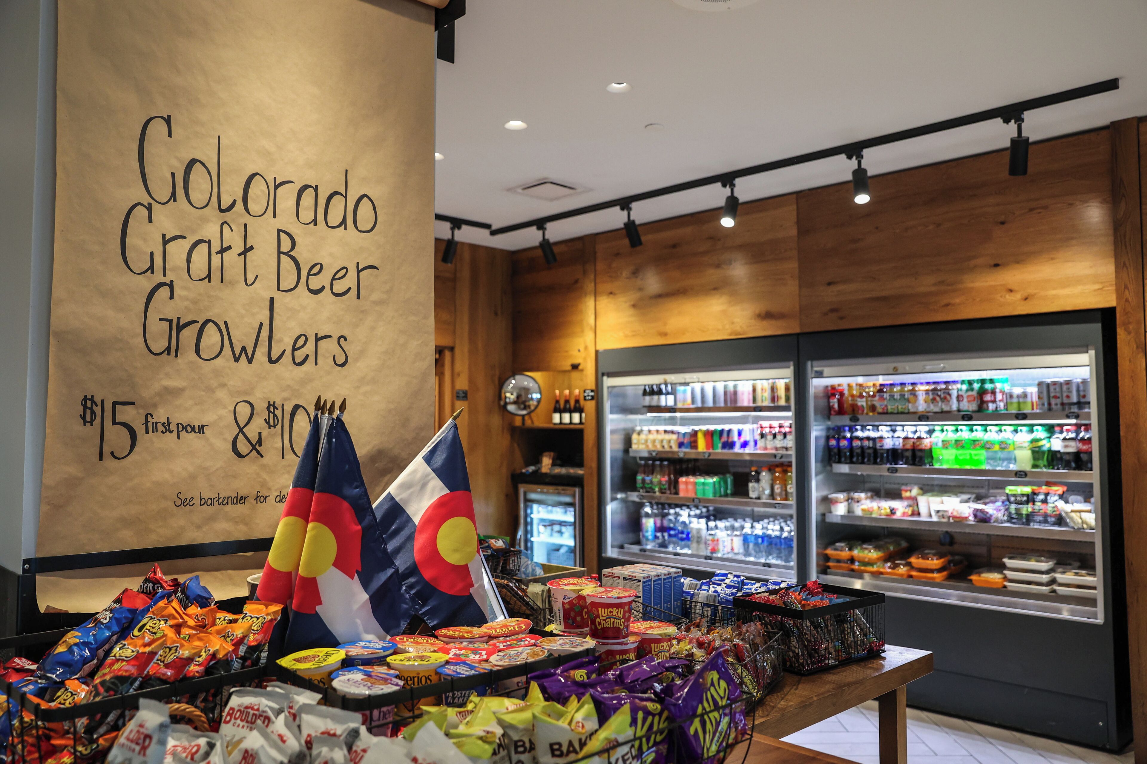 A Colorado Craft Beer Growlers display with a price tag of $15 first pour and $10.