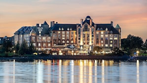 A large, historic hotel with multiple stories and a prominent dome, situated by a body of water. - Delta Hotels by Marriott Victoria Ocean Pointe Resort (Victoria)
