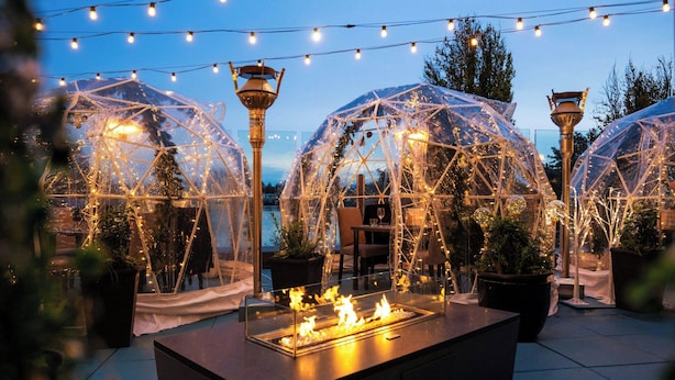 A terrace with transparent geodesic domes, a central fire feature, and string lights. - Delta Hotels by Marriott Victoria Ocean Pointe Resort (Victoria)