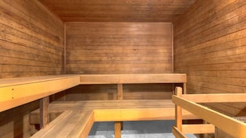 A sauna with wooden benches and a tiled floor.
