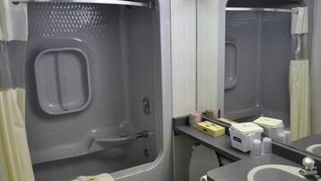 A compact bathroom with a bathtub, toilet, and sink.