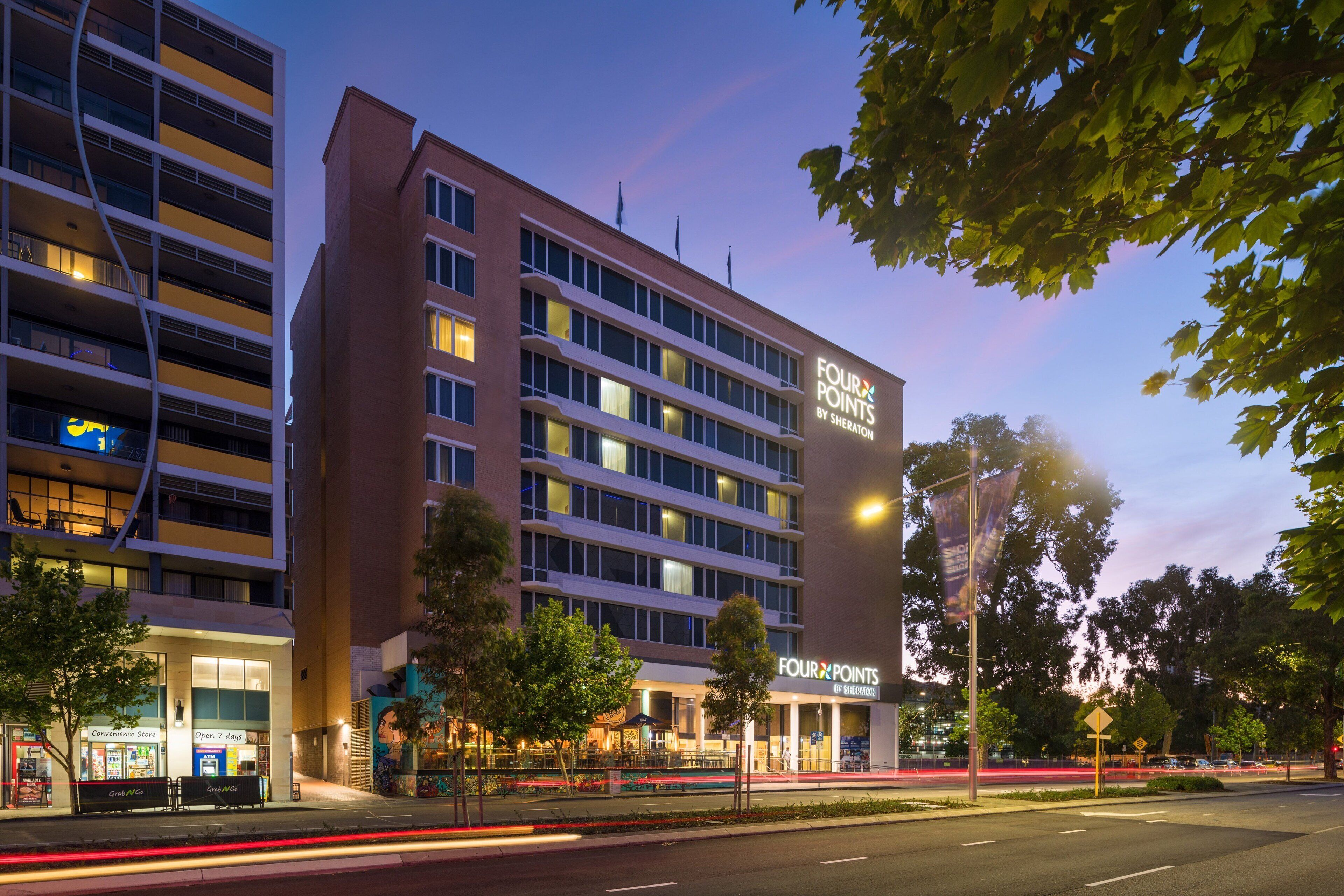 A multi-story hotel with a prominent sign reading "Four Points by Sheraton."