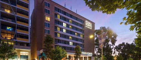 A multi-story hotel with a prominent sign reading "Four Points by Sheraton."