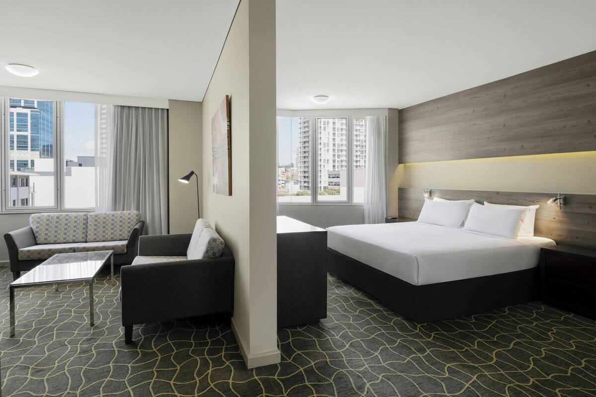 Deluxe Suite, 1 Bedroom, Corner | In-room safe, desk, laptop workspace, blackout drapes