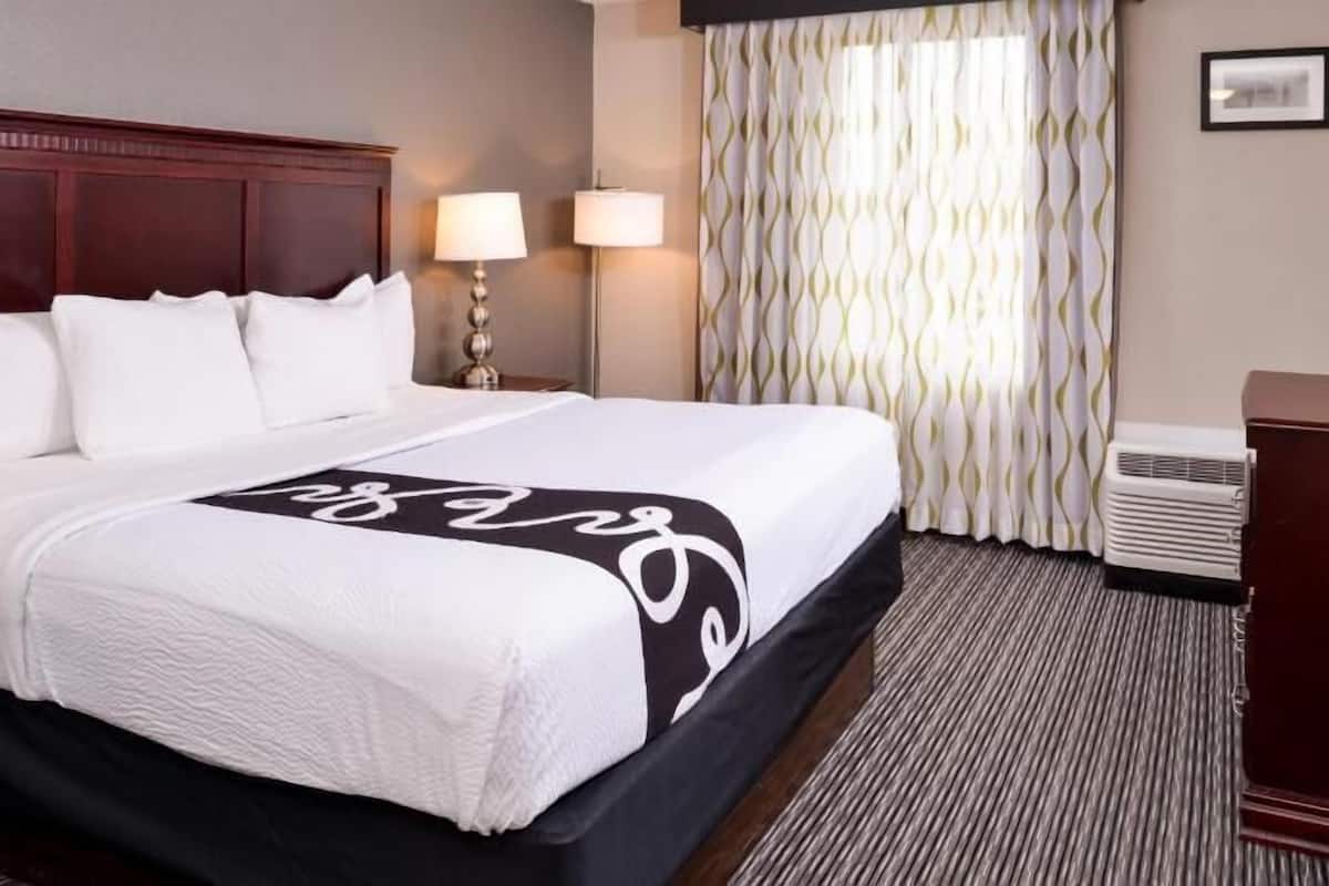 Desk, laptop workspace, blackout drapes, iron/ironing board