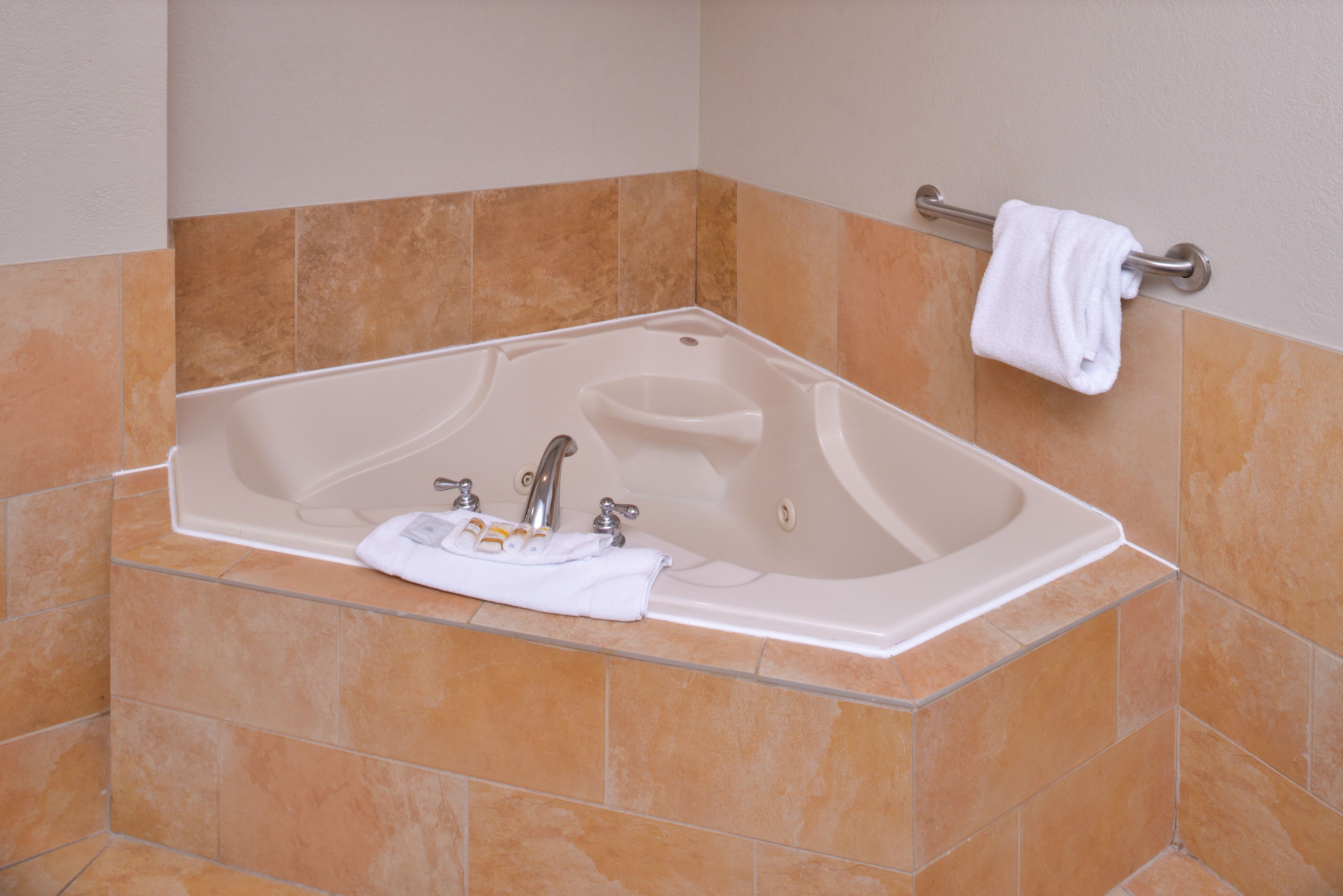 A modern bathroom with a freestanding bathtub, a towel rack, and a glass shower enclosure.