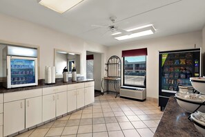 A kitchen with a refrigerator, a coffee machine, and a microwave. - Red Roof Inn Winchester, VA (Winchester)