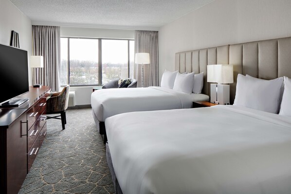 Relax in this stylish room with two beds, a flat-screen TV, and a comfortable armchair.