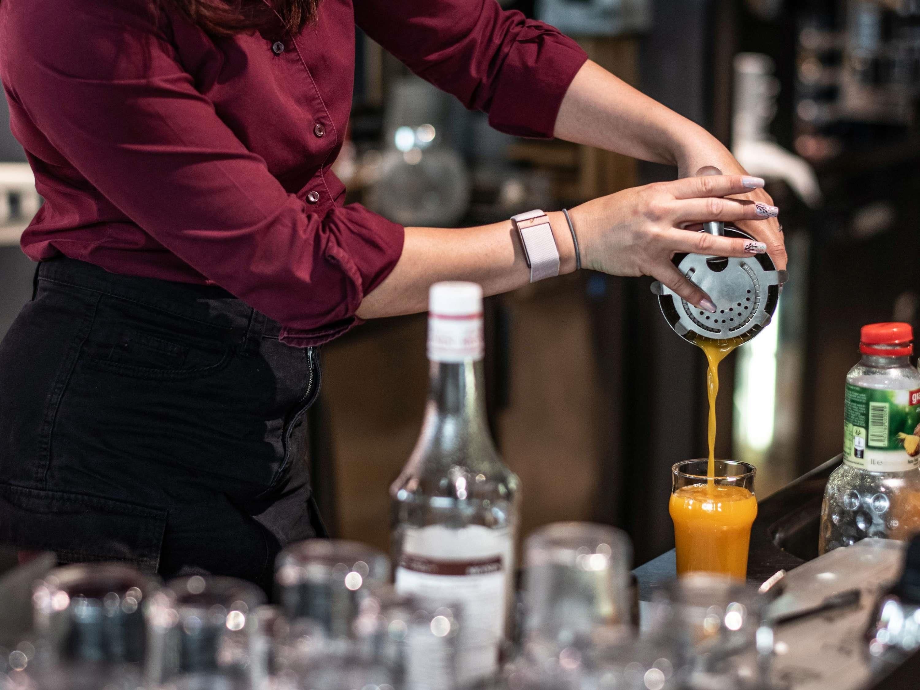 A person pouring a liquid into a glass.