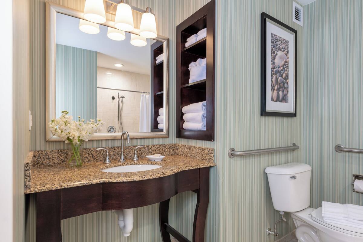 ada atlantic view king room balcony with roll-in shower | bathroom | eco-friendly toiletries, hair dryer, towels