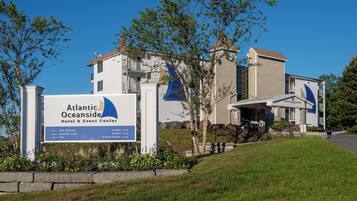 A hotel sign for Atlantic Oceanside Hotel & Event Center with directional arrows to The Willows, Atlantic View, and Pier.