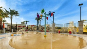 A water play area with multiple fountains and colorful play structures. - Drury Plaza Hotel Orlando - Disney Springs Area (Lake Buena Vista)