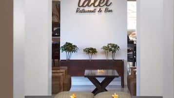 Relax in the central seating area with a dark table and cushioned benches.