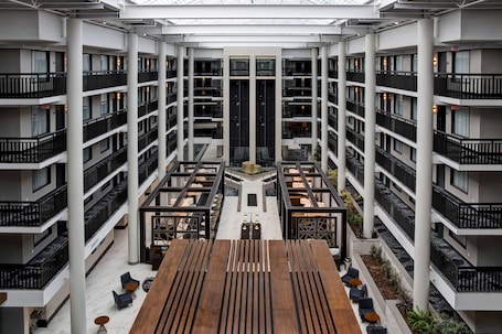 A multi-level atrium with a central open space, surrounded by balconies and seating areas.
