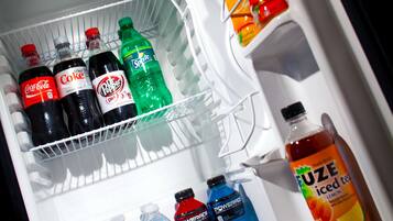 A refrigerator stocked with various beverages including Coca-Cola, Diet Coke, Sprite, Dr. Pepper, Powerade, and Fuze iced tea.