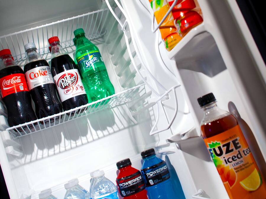 A refrigerator stocked with various beverages including Coca-Cola, Diet Coke, Sprite, Dr. Pepper, Powerade, and Fuze iced tea.