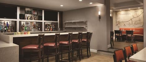 A bar area with wooden bar stools, a countertop with bottles, and a wall map labeled "TEMECULA".