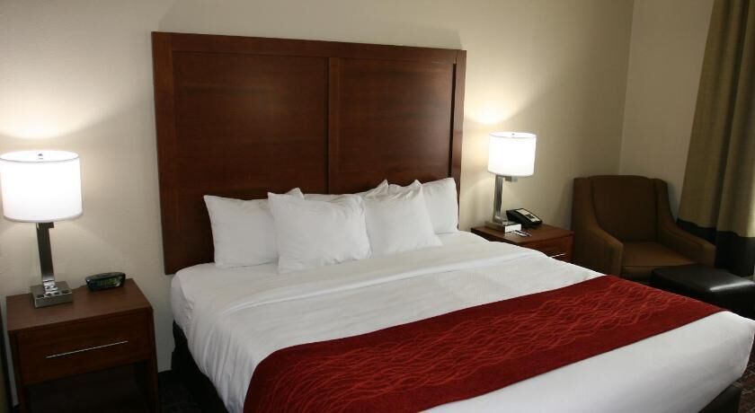 Premium bedding, desk, laptop workspace, blackout drapes