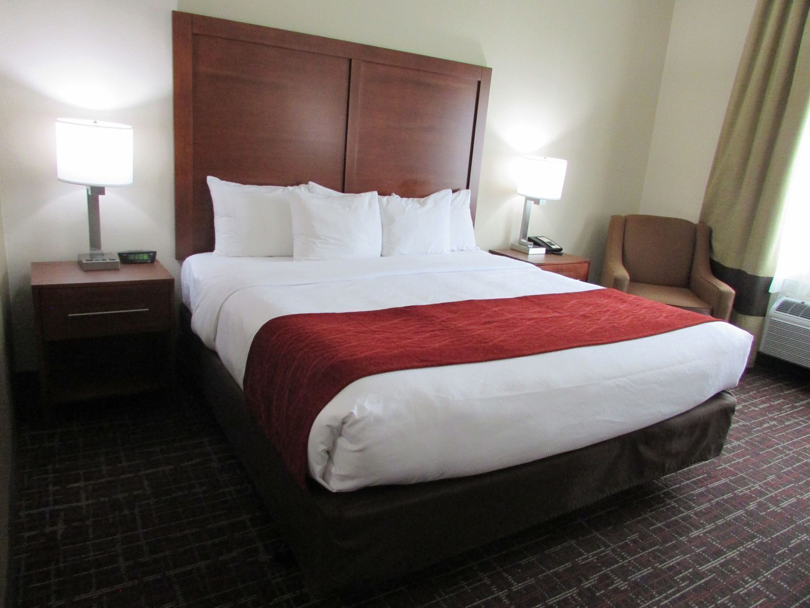 Premium bedding, desk, laptop workspace, blackout drapes