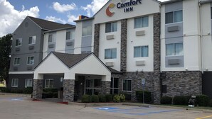 A Comfort Inn hotel with a modern design, featuring a stone facade and multiple windows. - Comfort Inn Wichita Falls Near University (Wichita Falls)