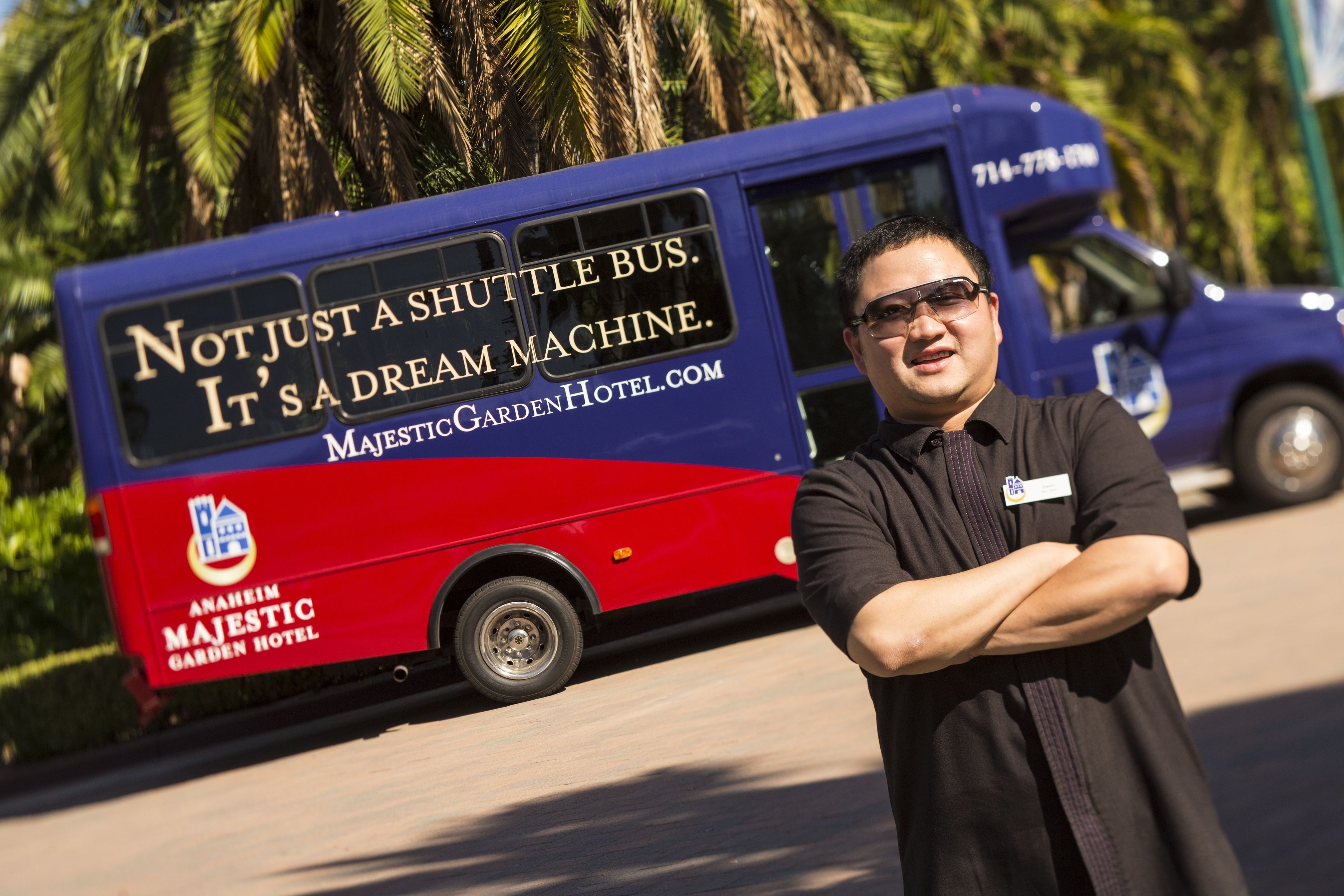 A shuttle bus with the text "Not just a shuttle bus. It's a dream machine." and "Anaheim Majestic Garden Hotel".