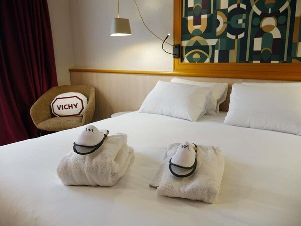 A hotel room with a bed, pillows, a chair with a sign, and a painting on the wall.