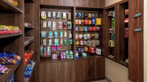 A store with shelves stocked with various snacks, toiletries, and personal care items. - Red Roof Inn PLUS+ Miami Airport (Miami)