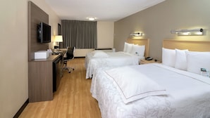 A hotel room with two beds, a desk, a television, and a chair. - Red Roof Inn PLUS+ Miami Airport (Miami)