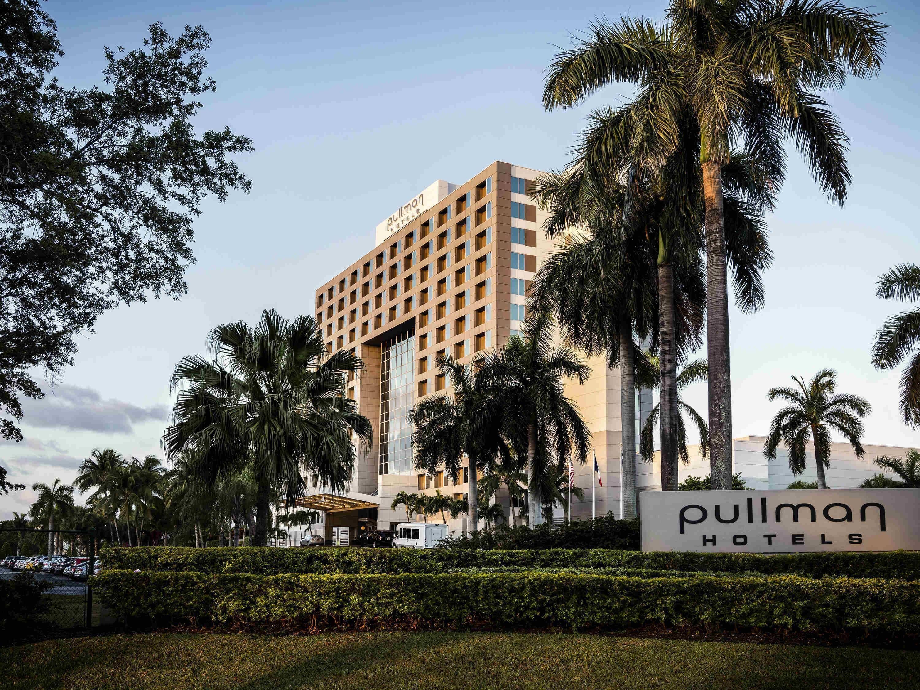 A hotel building with a sign reading 'Pullman Hotels.'