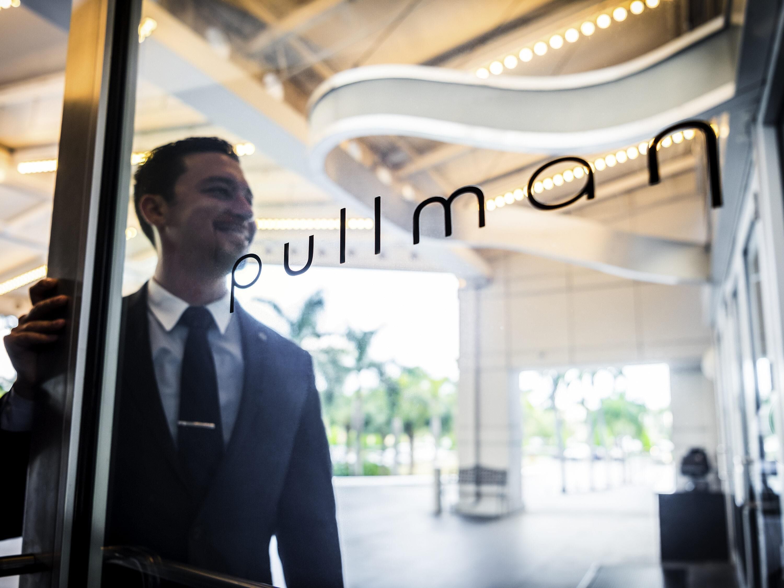 A man in a suit holding a door, with the word 'pull' visible.