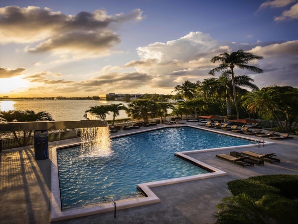 Outdoor pool, open 7:00 AM to 8:00 PM, pool loungers