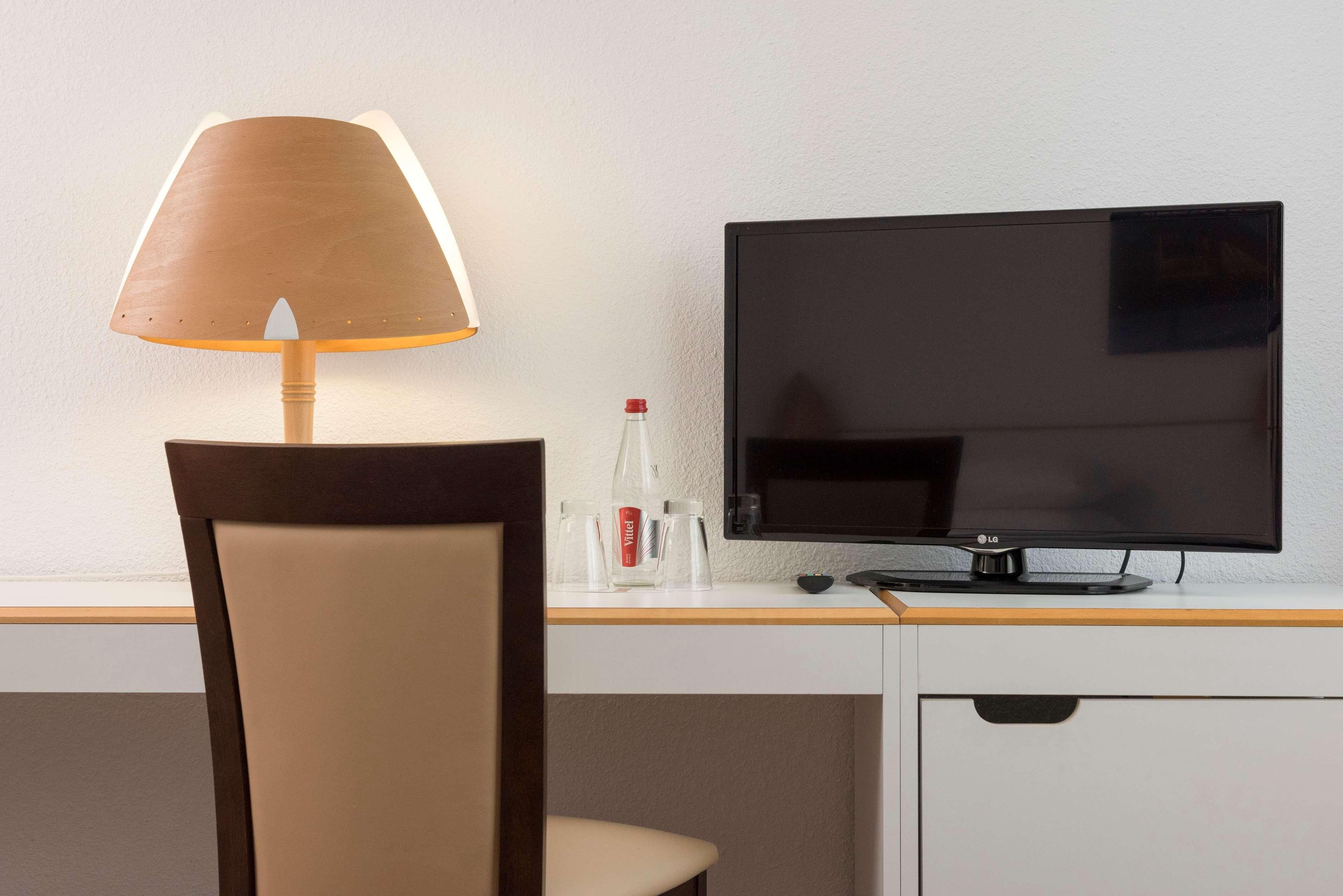 Hypo-allergenic bedding, desk, laptop workspace, blackout drapes