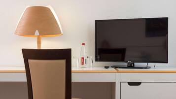 Hypo-allergenic bedding, desk, laptop workspace, blackout drapes