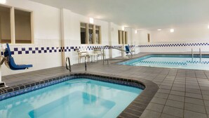 An indoor swimming pool with tiled flooring and a checkered border. - Baymont by Wyndham Salina (Salina)