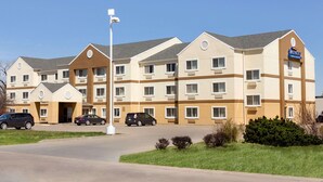 A multi-story hotel with a beige and brown color scheme, featuring a prominent 'Baymont' sign. - Baymont by Wyndham Salina (Salina)