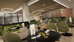 A modern restaurant with green upholstered booths, black tables, and a menu stand. - Crowne Plaza Harrogate by IHG (Harrogate)