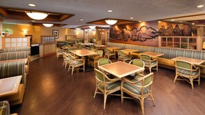 A restaurant with booths, tables, and chairs.