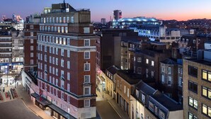 A hotel with a prominent corner location, large windows, and a visible entrance. - Radisson Blu Hotel, London Bond Street (London)
