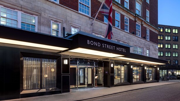 The Bond Street Hotel entrance with a modern facade, large glass doors, and a flag. - Radisson Blu Hotel, London Bond Street (London)