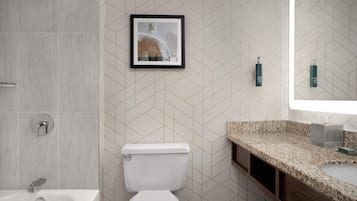 A modern bathroom with a toilet, sink, and shower.