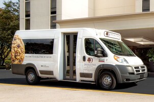 A white DoubleTree by Hilton van parked in front of a building.