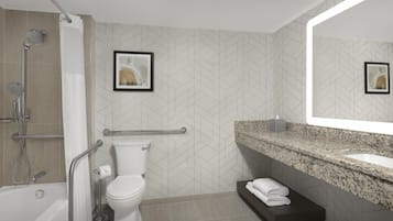 Une salle de bain moderne équipée d’une douche, de toilettes, d’un meuble-lavabo et d’un grand miroir.