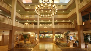 A spacious lobby with a grand chandelier, multiple balconies, and a central reception area. - Disney's Vero Beach Resort (Vero Beach)