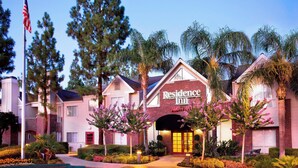 A hotel with a prominent "Residence Inn" sign, surrounded by palm trees and well-maintained landscaping. - Residence Inn by Marriott Bakersfield (Bakersfield)