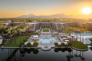 A spacious lobby with a view of a golf course, large potted plants, and a patterned floor. at Grand Hyatt Scottsdale Resort